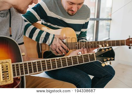 Learning to play the guitar. Music education and extracurricular lessons. Guitarist