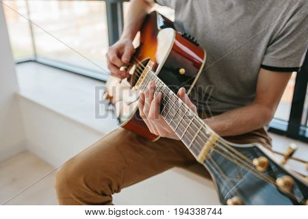Learning to play the guitar. Music education and extracurricular lessons. Guitarist