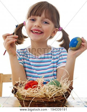 a happy little girl coloring easter eggs - white background