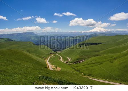 High Mount Elbrus, beautiful view of snow tops, mountain panorama, sights and mountains of the North Caucasus, trailering, mountain road
