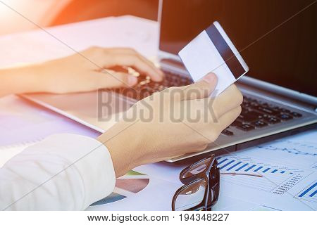 Woman's Hands Holding A Credit Card And Using Smart Phone For Online Shopping.vintage Tone