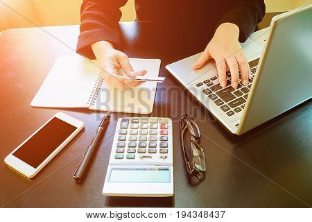 Woman's Hands Holding A Credit Card And Using Smart Phone For Online Shopping.vintage Tone