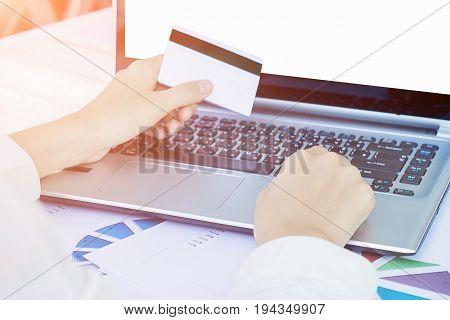 Woman's Hands Holding A Credit Card And Using Smart Phone For Online Shopping.vintage Tone