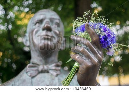 Blue flowers in a sculpture hand of Danielius Dolskis popular Lithuanian singer noted in pre-revolutionary Russia and in inter-war Lithuania.