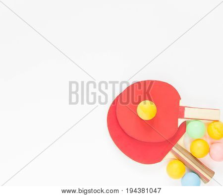 Sport background. Red ping-pong rackets and varicolored balls. Flat lay top view