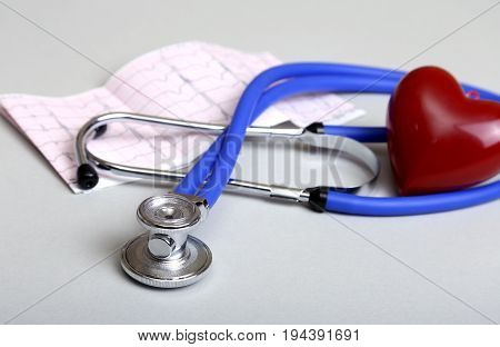 RX prescription, Red heart, asorted pils and a stethoscope on white background.