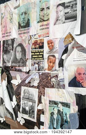 LONDON UK - JULY 5 2017: Fading posters stuck on the side of a telephone box asking for information on residents of the Grenfell Tower block of flats which caught fire killing at least 80 people.