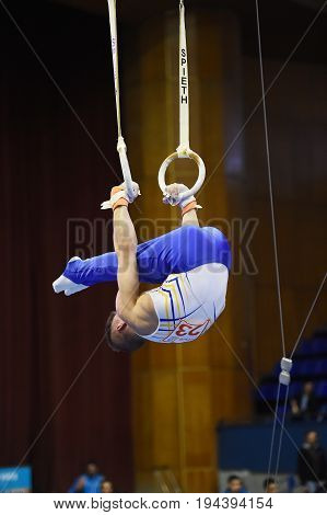 Kyiv. Ukraine-April 1, 2017 : Male gymnast performing on stationary gymnasic rings during Stella Zakharova Artistic Gymnastics Cup