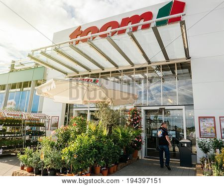 FRANKFURT GERMANY - JUN 30 2017: Adult man walking to the entrance of TOOM the German DIY-store chain offering home improvement and do-it-yourself goods - customers buying goods selecting the best tools