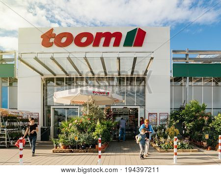 FRANKFURT GERMANY - JUN 30 2017: People entering walking to the entrance of TOOM the German DIY-store chain offering home improvement and do-it-yourself goods - customers buying goods selecting the best tools