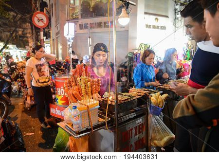 Hanoi Vietnam - Feb 19 2107 : a Women selling sausage at Hanoi night walking street