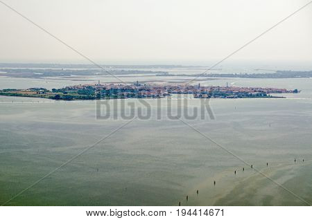 Aerial view of the Venetian Lagoon with the island of Murano to the fore and behind it the less populated Le Vignole and Saint'Erasmo with the Adriatic Sea beyond.