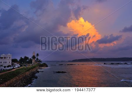 Galle lighthouse stands guard over the Indian ocean at sunset; SriLanka coast in 2016.