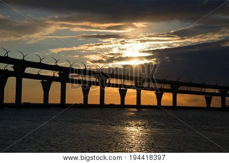 Silhouette of a section of the Western high-speed diameter on a sunset background. Saint-Petersburg, Russia