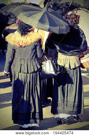 Ladies Dressed In Vintage Clothes And An Umbrella With Vintage E