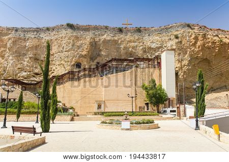 Dheftera Nicosia CYPRUS - MAY 30 2014 : View on the Panagia Chrysospiliotissa Church. The church of Panagia Chrysospiliotissa is built in the natural sandstone cave in which were formed an apse a nave narthex and vestries