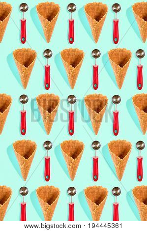 Ice cream cones pattern. Turquoise background. Sweet, summer and empty concept. Top view. Flat lay