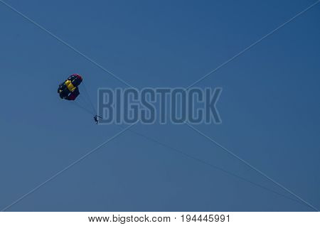 Parachuting along the coast of the sea.