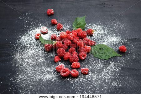 Ripe and tasty raspberries on a wooden background. Raspberries on wooden table .Fresh , vitamins healthy food vegan ingredients.