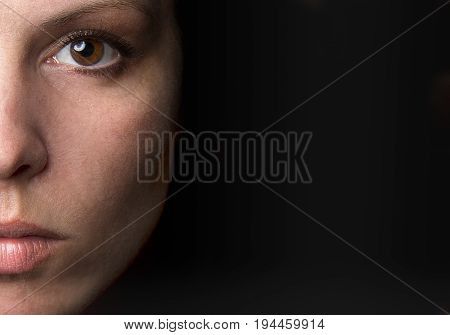Portrait of a young women with black background