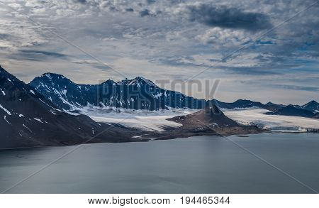 Glacier and mountain range under the clouds Svalbard