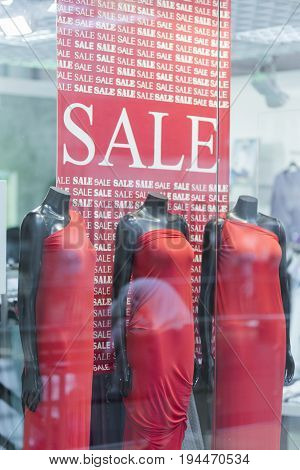 Storefront of women's clothing with the inscription Sale.
