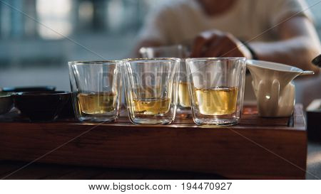 Glass Pialas At The Tea Ceremony Close-up. Transparent Bowls For Drinking Chinese Large-leaf Tea. Te