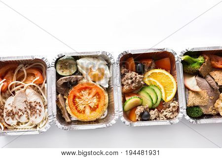 Healthy restaurant lunch. Everyday organic food delivery. Daily fitness menu. Dietary steamed meat with garnish and vegetable salads in boxes on white background