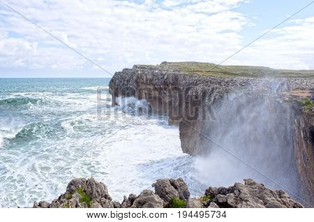 Waves Splashing Against The Rocks Of A Cliff In Pria, Spain
