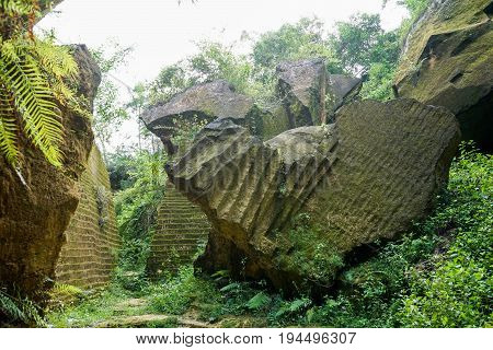 The exploitation of limestone hills canyon forming a unique architectural in Arosbaya Hill Madura Island, Indonesia
