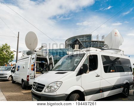 STRASBOURG FRANCE - JUN 30 2017: Mercedes Sprinter TV Media Television Trucks with multiple Satellite parabolic antennas and fiber optic cables preparing to report live the official European Ceremony of Honour for Dr. Helmut Kohl at European Parliament