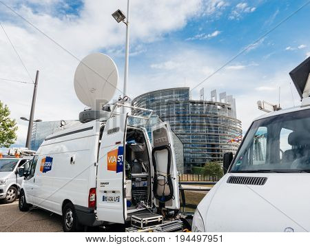 STRASBOURG FRANCE - JUN 30 2017: Via storia TV Media Television Trucks with multiple Satellite parabolic antennas and fiber optic cables preparing to report live the official European Ceremony of Honour for Dr. Helmut Kohl at European Parliament
