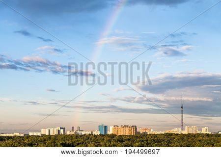 Rainbow In Evening Sky Over Residential District