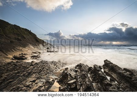 Beautiful Colorful Vibrant Sunset Over Rocky Beach With Long Exposure