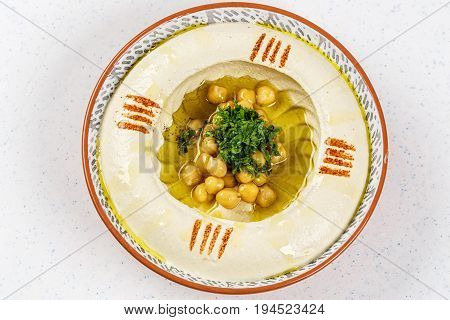 arabic food Hummus with parsley in a traditional bowl and nuts