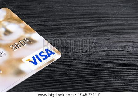 Sankt-Petersburg Russia July 09 2017: Visa credit cards on office black desk board. close up view of a visa credit card on black wooden table. Photo taken in Sankt-Petersburg Russia July 09 2017