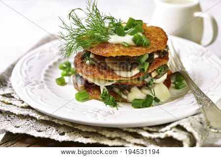 Draniki -potato Pancakes With Mushrooms And Cream Sauce.