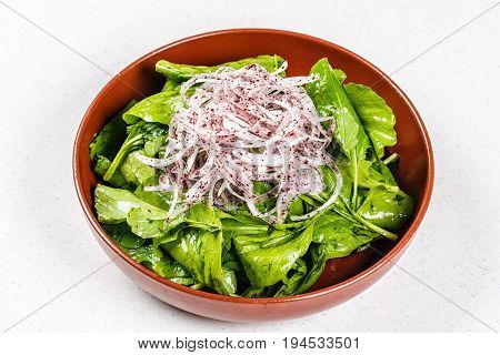 Fresh healthy garden salad with Rocket on brown plate
