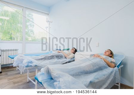 Female patient sleeping in medical bed at the hospital ward.