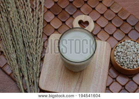 Coix lacryma-jobi, boiled in a glass on a brown background