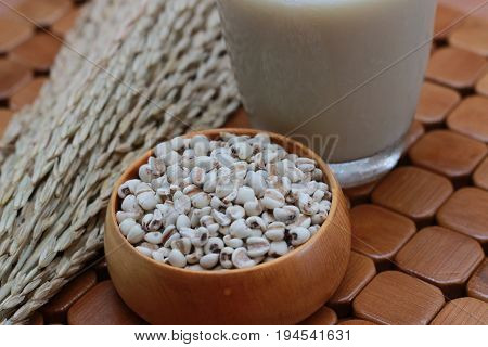 Coix lacryma-jobi, boiled in a glass on a brown background