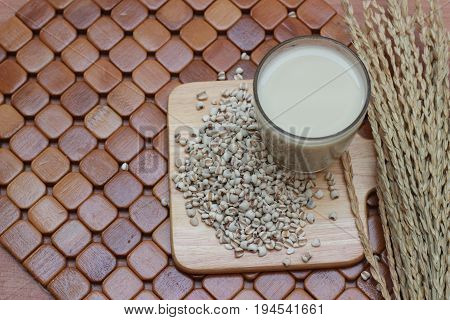 Coix lacryma-jobi, boiled in a glass on a brown background