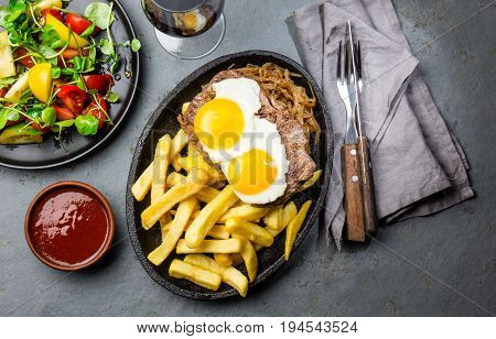 Peruvian Latin American food. Lomo a lo pobre. Beef whit fried potatoes french fry and eggs