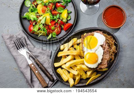 Peruvian Latin American food. Lomo a lo pobre. Beef whit fried potatoes french fry and eggs