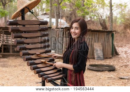 The lifestyle of rural girl playing Pong lang at countryside.