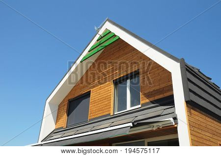 House Blinds Sun Protection Exterior. Windows in New Modern Passive House Facade Wooden Wall with Shutters Closed and Opened Modern House Outdoors. Protection Against Sun and Heat as Energy Saving.