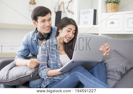 Young Man Using Laptop And Woman With Happy Emoyion At Living Room People Lifestyle Concept.