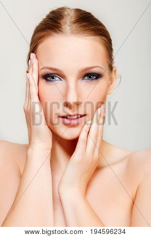Attractive blonde topless woman with dark eye make up
