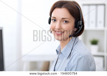 Young beautiful business woman in headset. Call center.