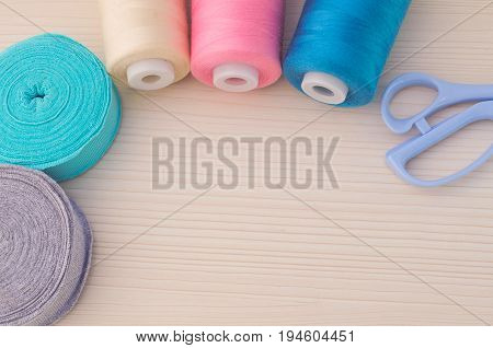 Sewing kit. Thread blue, pink, beige, scissors,rolls ribana grey and menthol